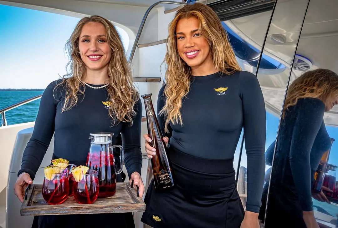 Crew with a drinks tray aboard the Azimut L'chaim